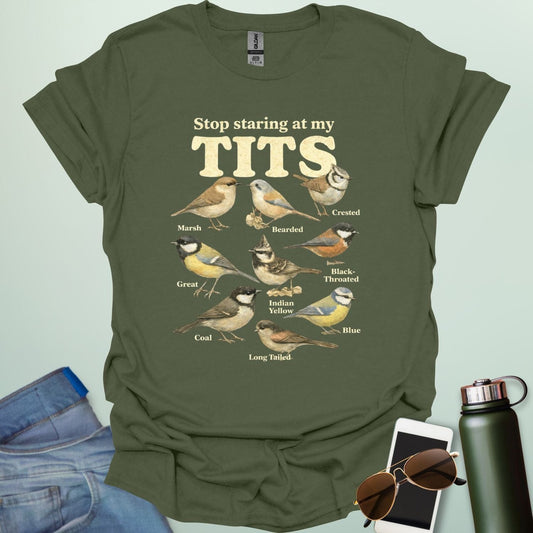 A t-shirt featuring the text "Stop staring at my TITS" above nine vintage-style illustrations of different tit bird species, including the Bearded, Crested, and Long Tailed tits.