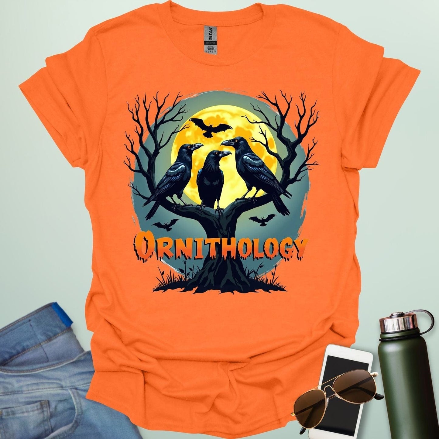 Ornithology Raven Halloween t-shirt featuring a raven perched with spooky Halloween elements — science & bird lover design.