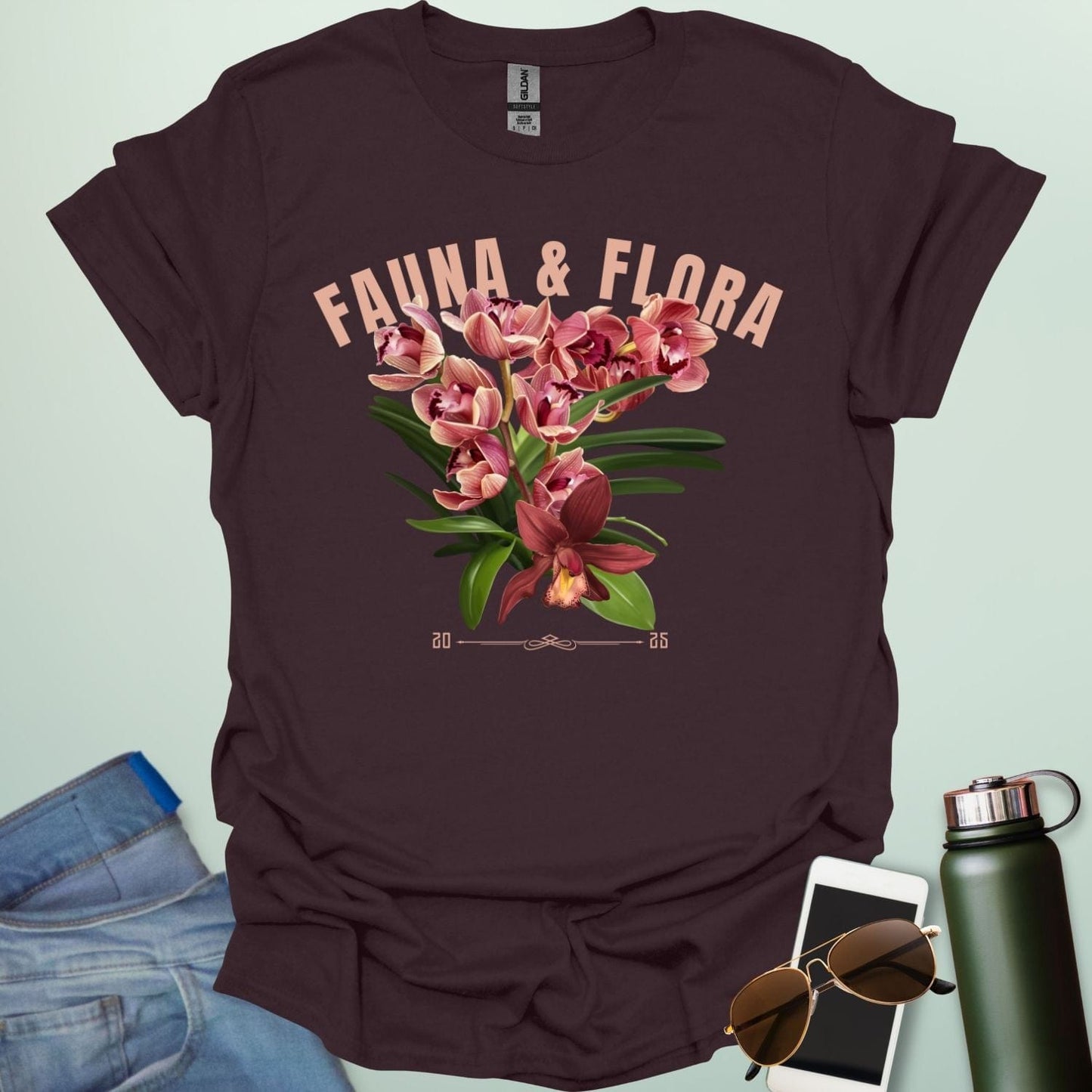 A beautiful t-shirt with a detailed illustration of a pink orchid and green leaves, perfect for gardeners and nature lovers.