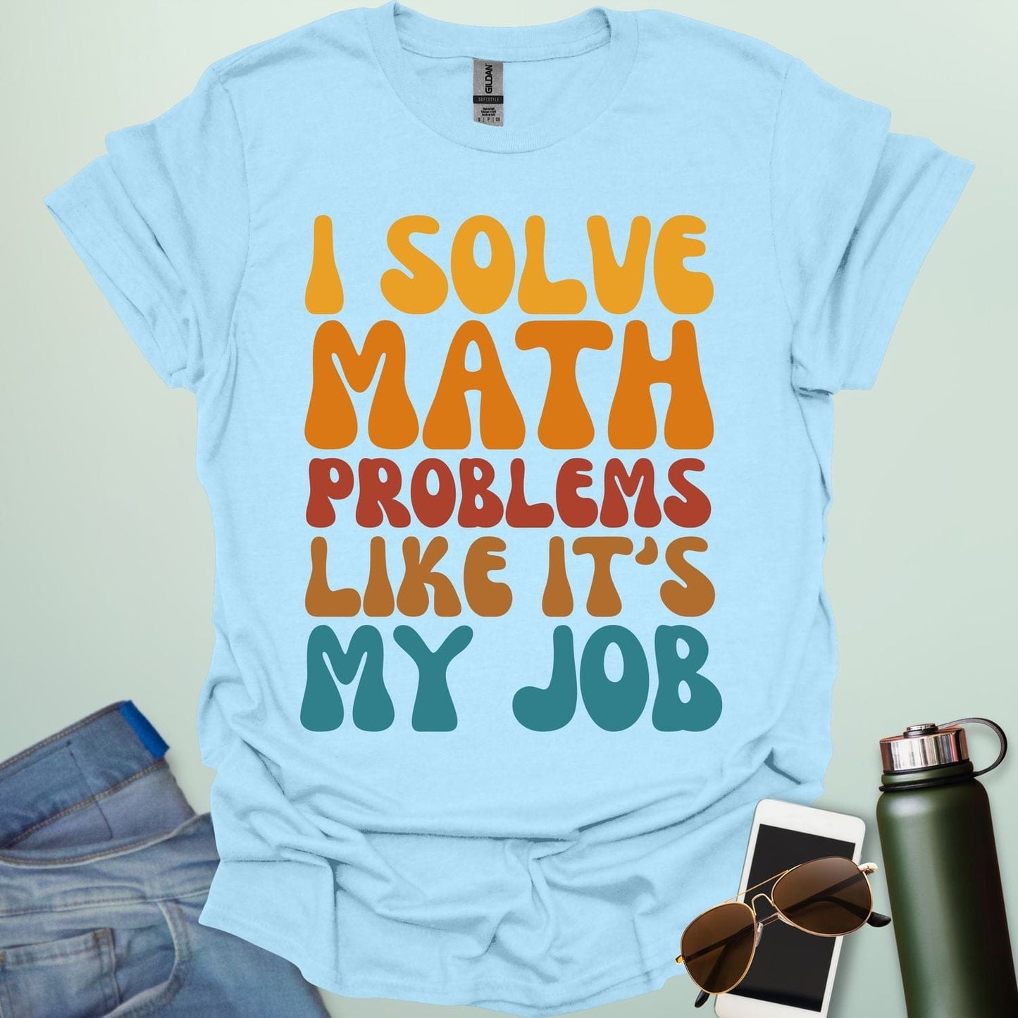 A t-shirt with the text 'I SOLVE MATH PROBLEMS LIKE IT'S MY JOB' printed in a retro, colorful, and bold font.