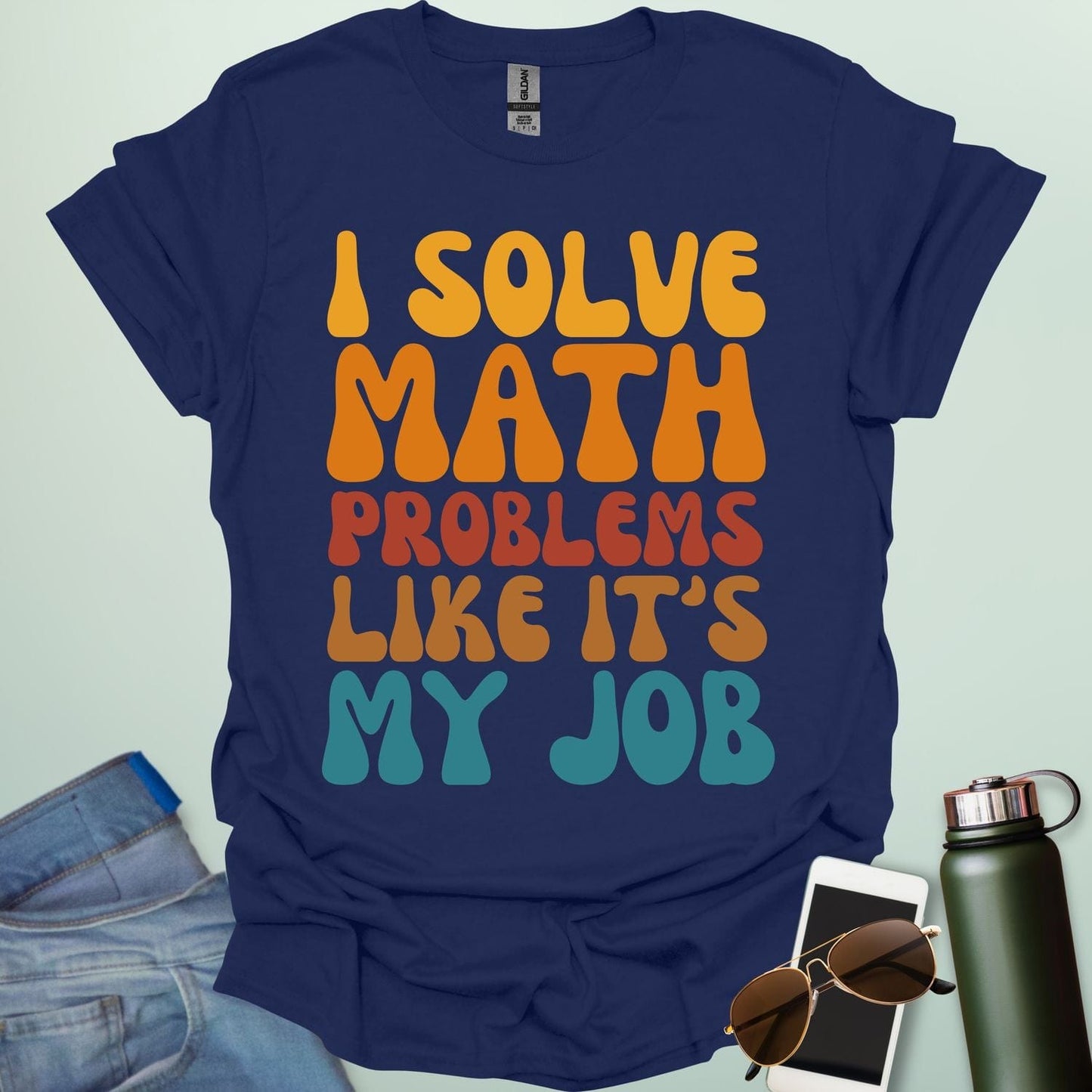 A t-shirt with the text 'I SOLVE MATH PROBLEMS LIKE IT'S MY JOB' printed in a retro, colorful, and bold font.