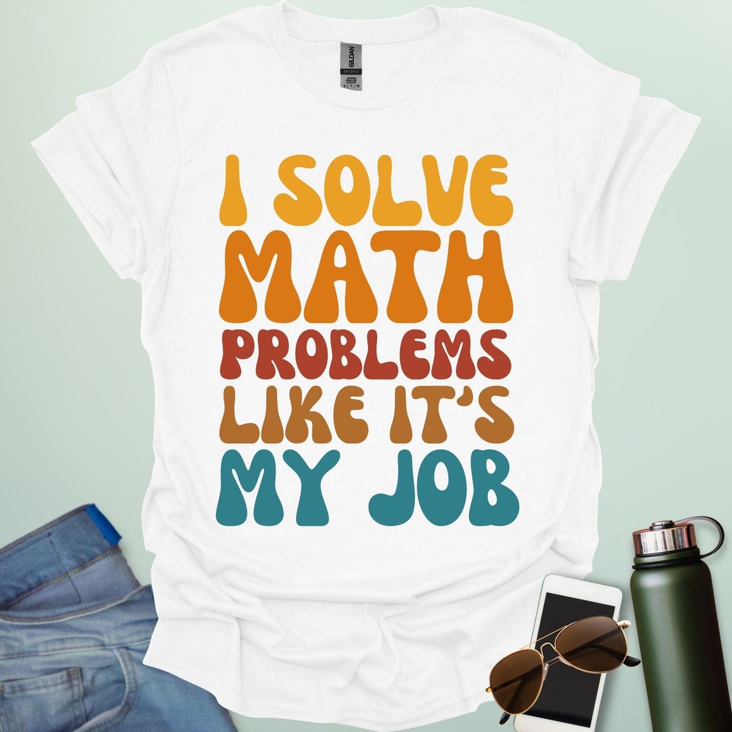 A t-shirt with the text 'I SOLVE MATH PROBLEMS LIKE IT'S MY JOB' printed in a retro, colorful, and bold font.