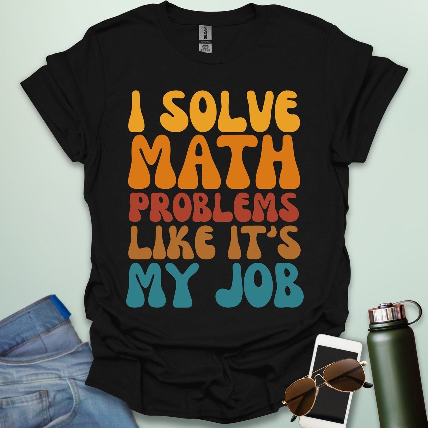 A t-shirt with the text 'I SOLVE MATH PROBLEMS LIKE IT'S MY JOB' printed in a retro, colorful, and bold font.