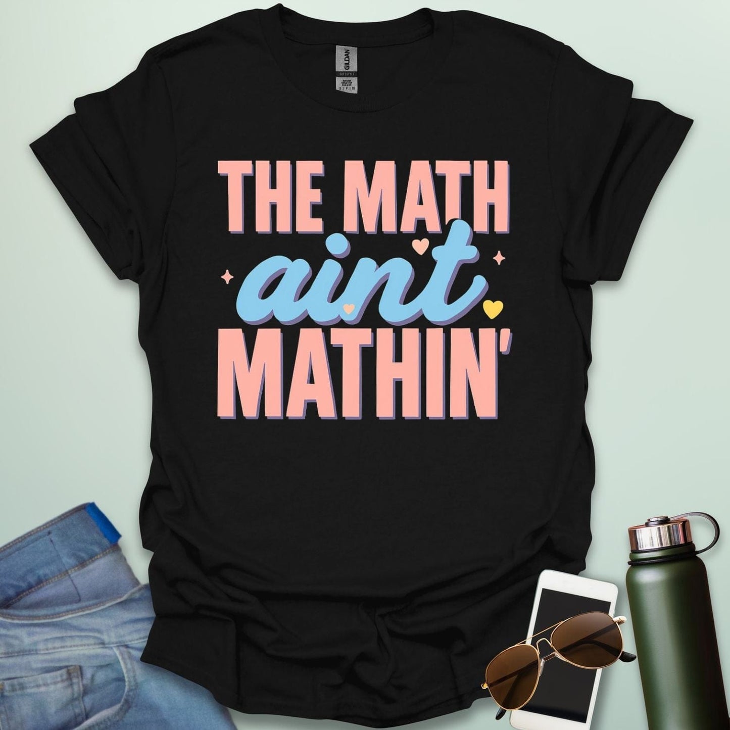 The Math Ain't Mathin'' t-shirt with stylized pink and blue lettering on a solid background.