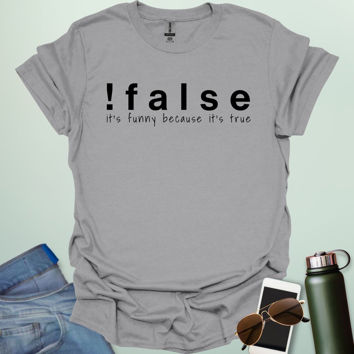 A sport grey shirt with the text '!false' in bold letters, with the tagline 'it's funny because it's true' in smaller letters below.