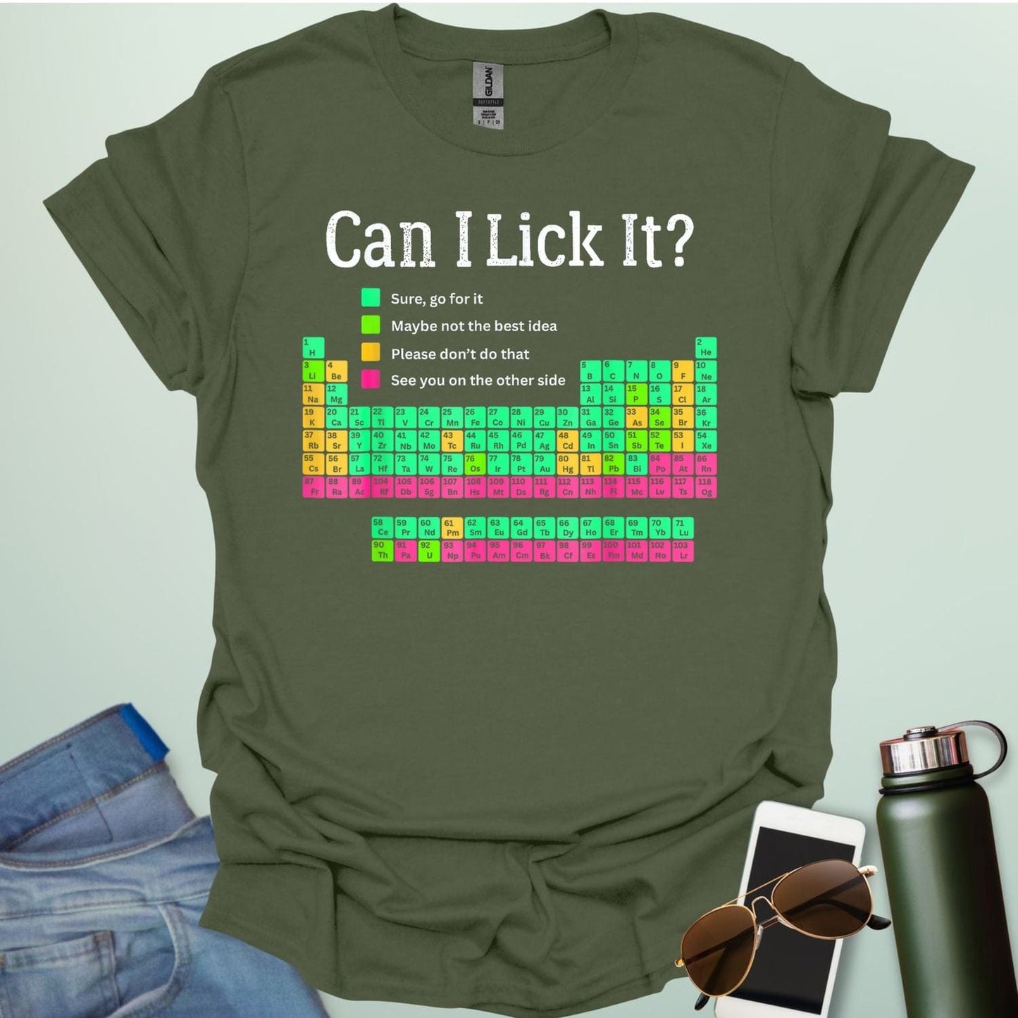 Can I Lick It?' periodic table t-shirt with a color-coded chart of elements and a funny chemistry warning.