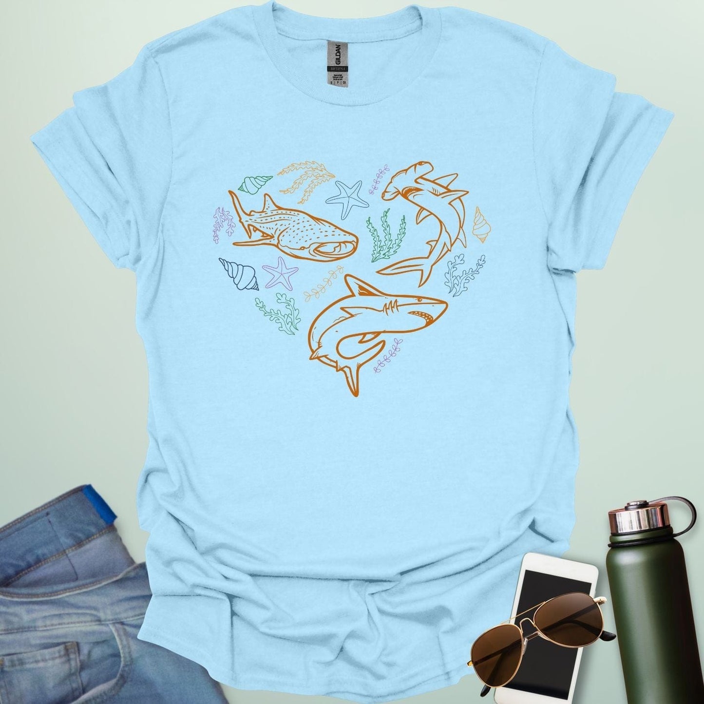 A collection of ocean animals, including sharks, sea stars, and seashells, arranged in a heart shape.