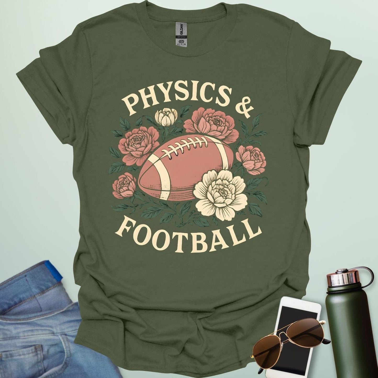 A military green t-shirt with a vintage illustration of a football surrounded by flowers and the text 'PHYSICS & FOOTBALL.'