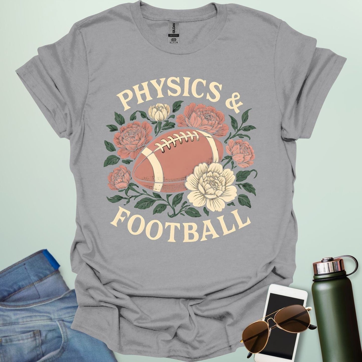 A sport grey t-shirt with a vintage illustration of a football surrounded by flowers and the text 'PHYSICS & FOOTBALL.'