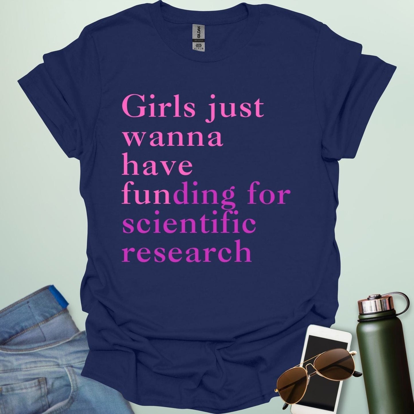 A navy blue t-shirt with the text 'Girls just wanna have funding for scientific research' in a pink serif font.
