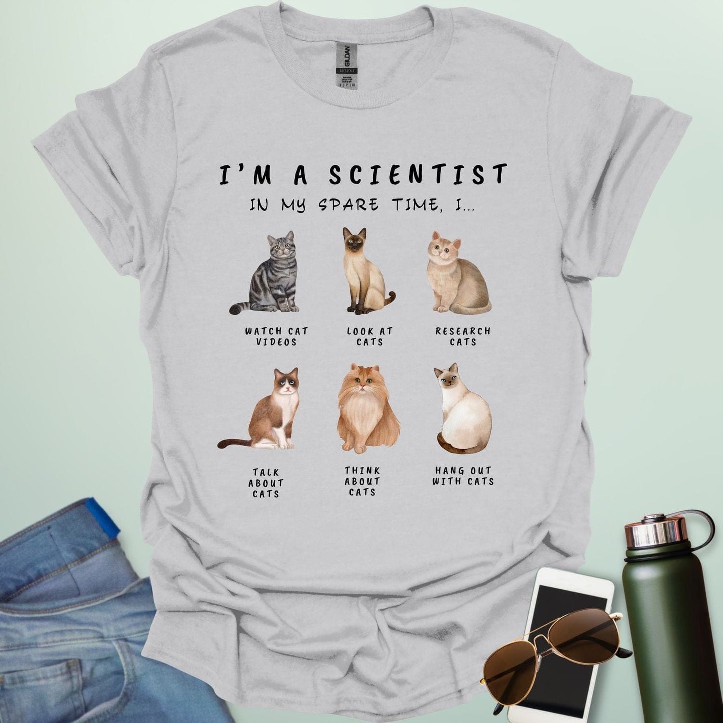 Ice Gray t-shirt with cat-themed text and illustrations on a light green background