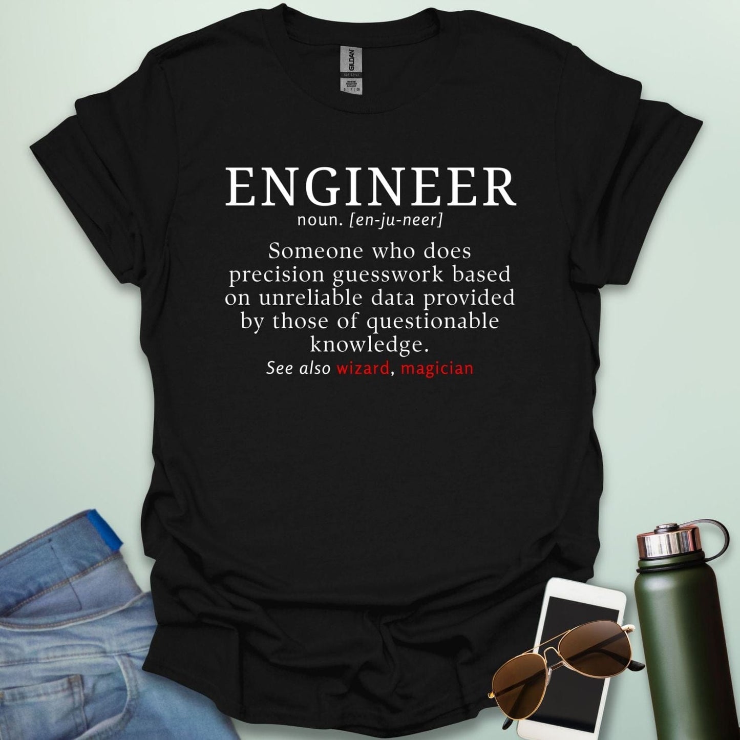 Engineer' t-shirt with a humorous dictionary-style definition and 'See also wizard, magician' in red.