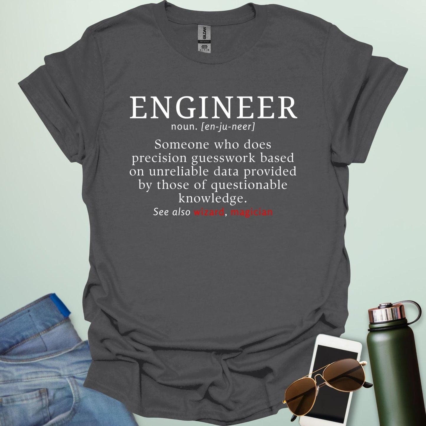 Engineer' t-shirt with a humorous dictionary-style definition and 'See also wizard, magician' in red.