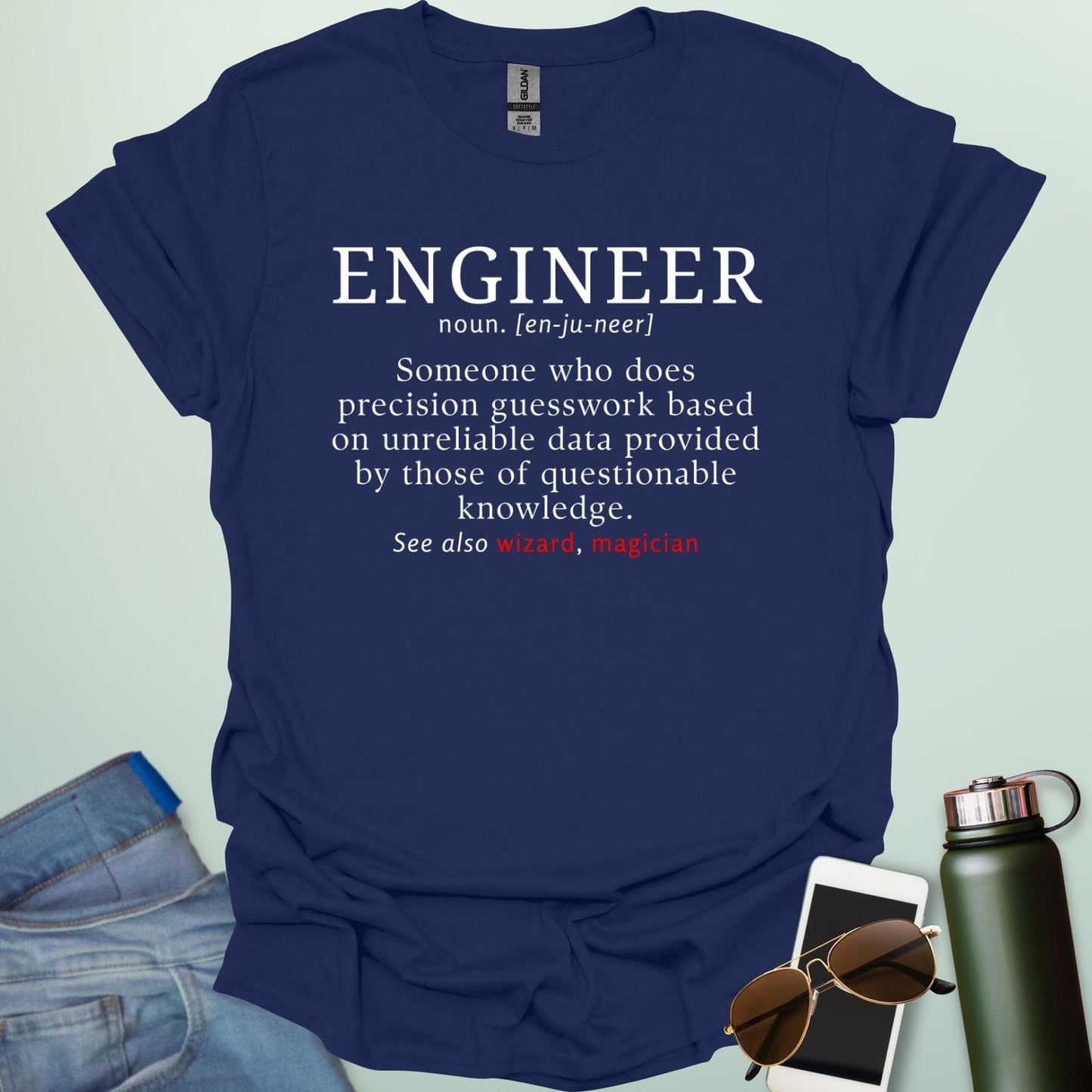 Engineer' t-shirt with a humorous dictionary-style definition and 'See also wizard, magician' in red.