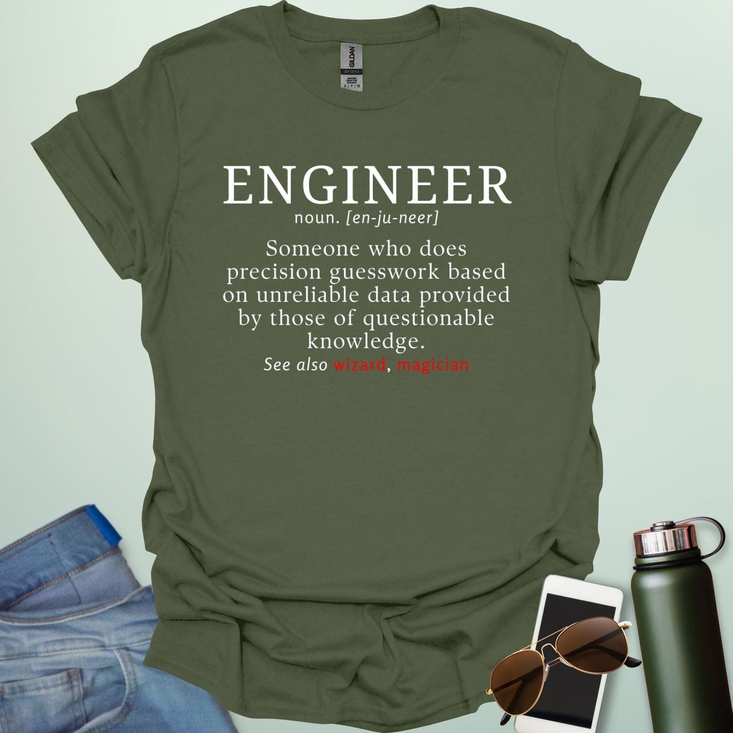 Engineer' t-shirt with a humorous dictionary-style definition and 'See also wizard, magician' in red.