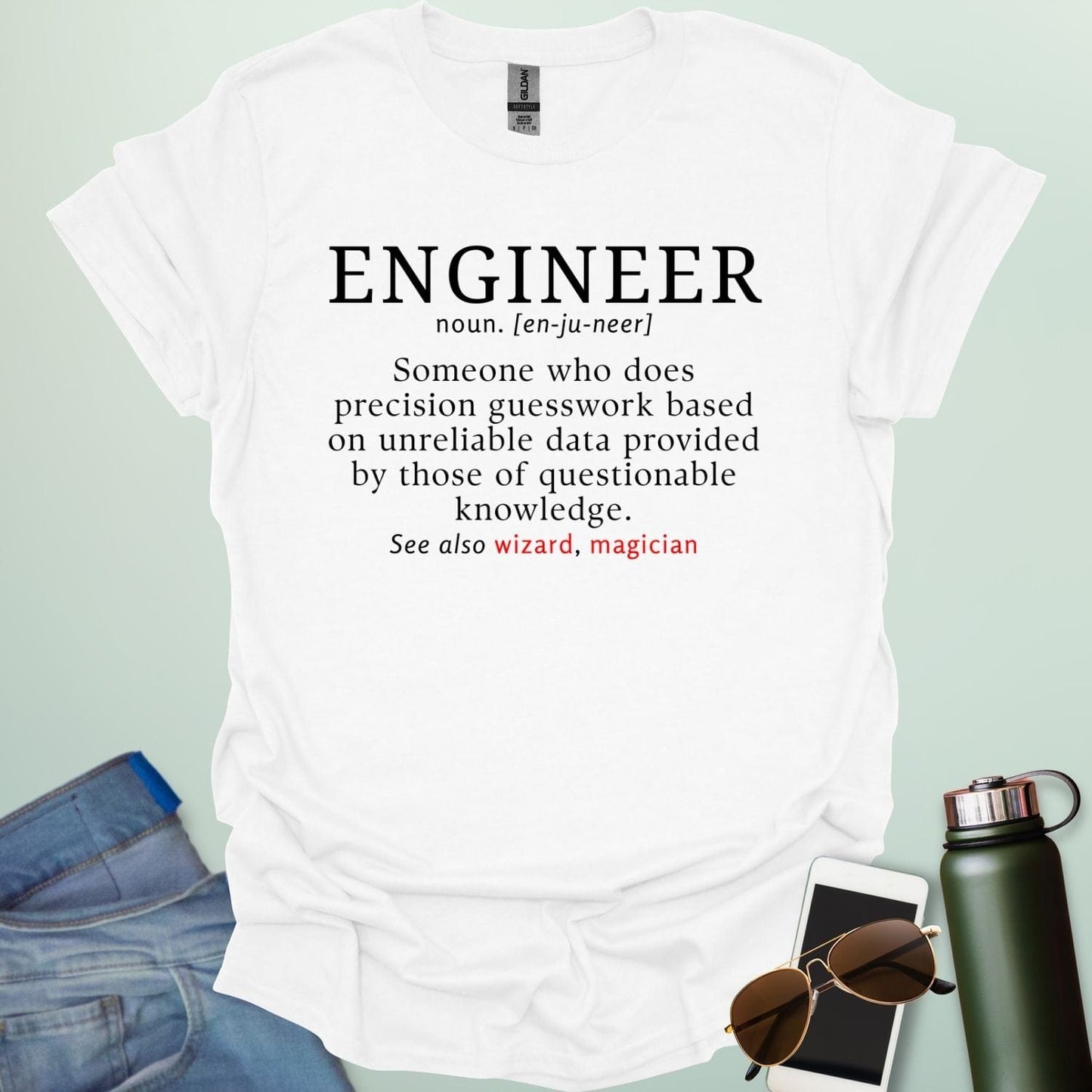 Engineer' t-shirt with a humorous dictionary-style definition and 'See also wizard, magician' in red.