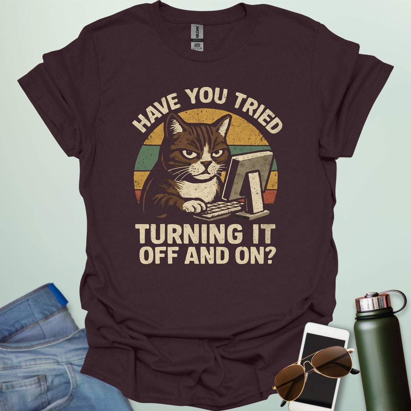 Funny 'Have You Tried Turning It Off and On' t-shirt with a retro-style cat at a computer.