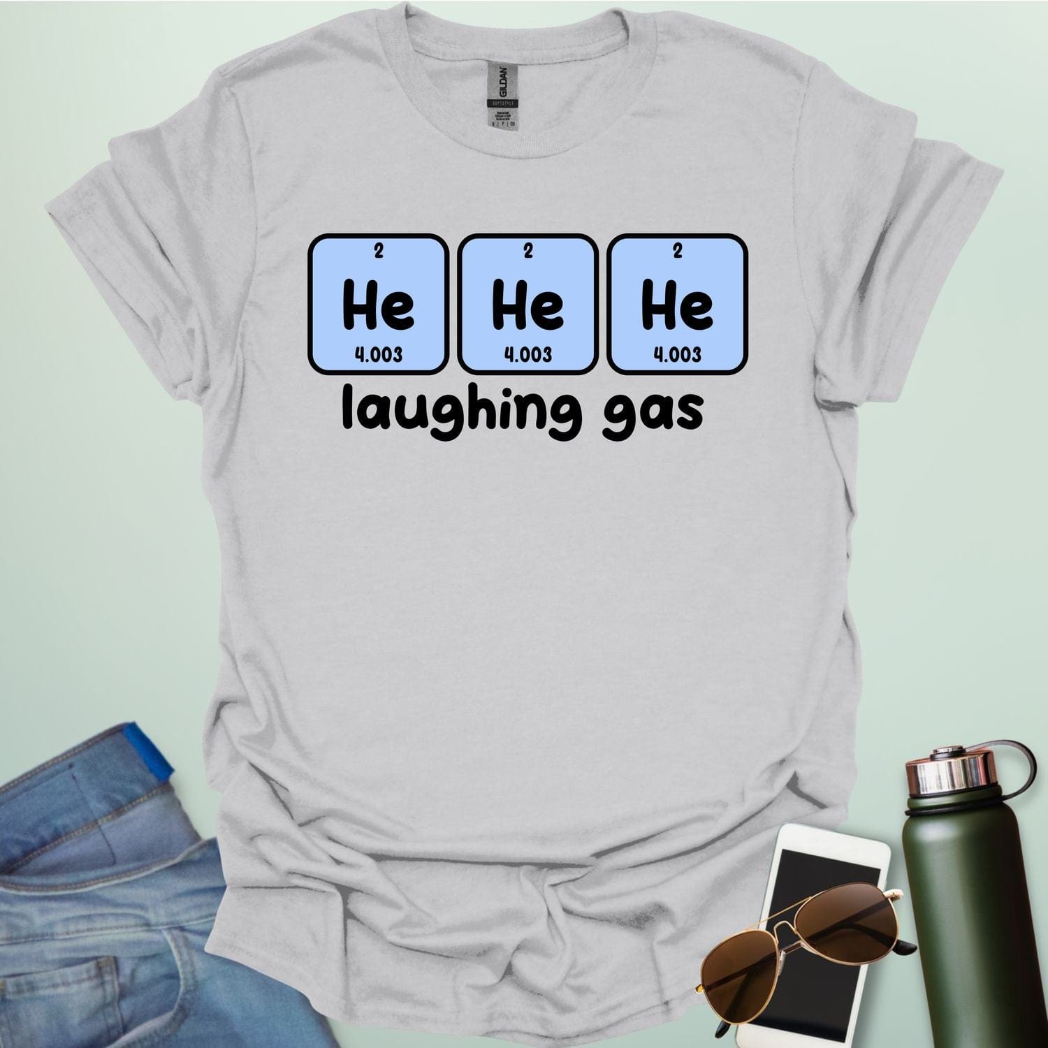 Three periodic table element boxes showing 'He' for Helium, with the text 'laughing gas' below.
