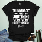A black t-shirt with the phrase 'THUNDERBOLT AND LIGHTENING VERY VERY FRIGHTENING ME' with lightning bolts, and '- Galileo' in script below.