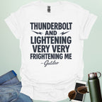 A white t-shirt with the phrase 'THUNDERBOLT AND LIGHTENING VERY VERY FRIGHTENING ME' with lightning bolts, and '- Galileo' in script below.