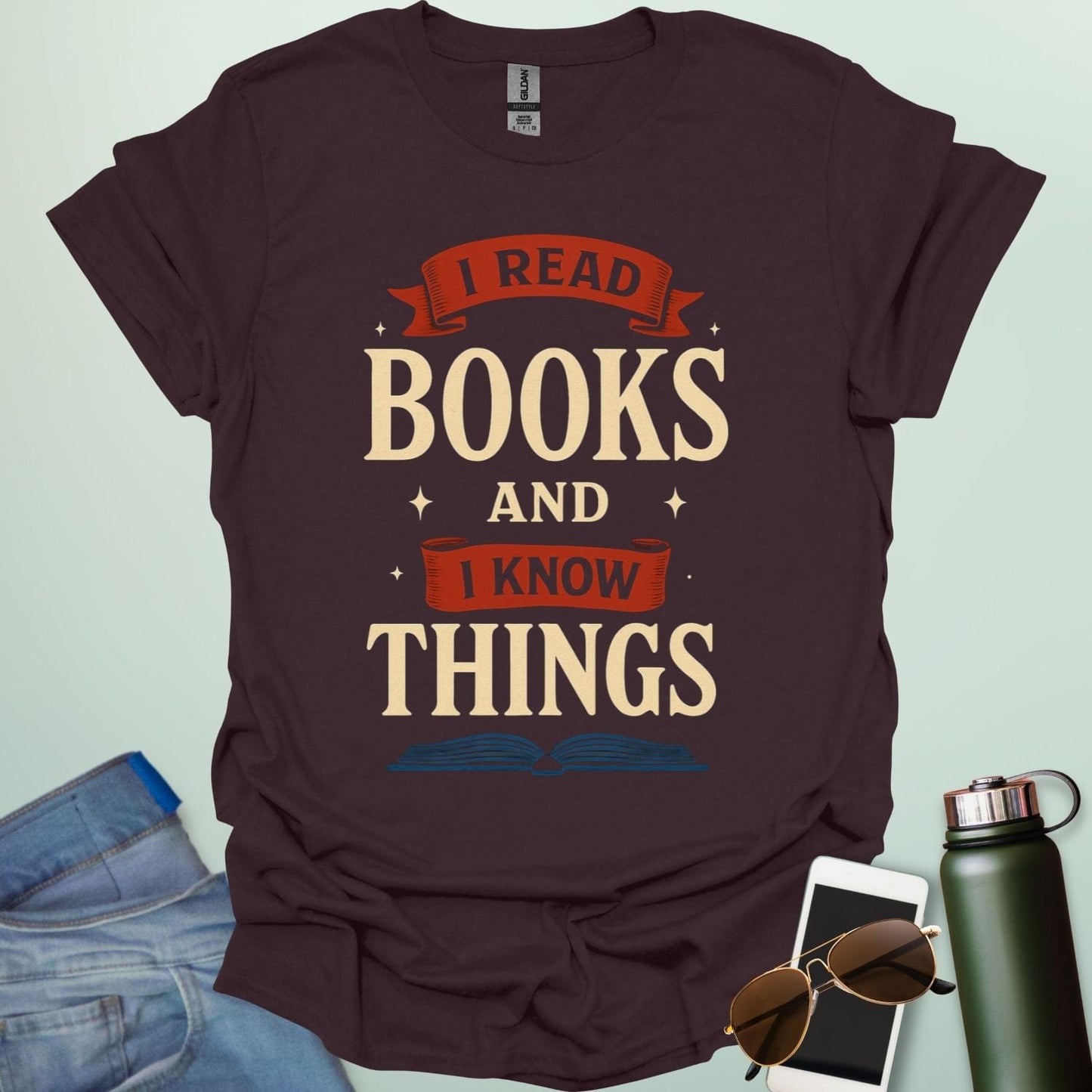 A dark chocolate t-shirt with the text 'I READ BOOKS AND I KNOW THINGS' and a graphic of an open book below it.