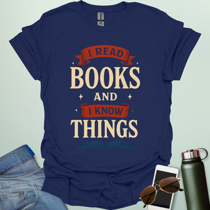 A navy blue t-shirt with the text 'I READ BOOKS AND I KNOW THINGS' and a graphic of an open book below it.