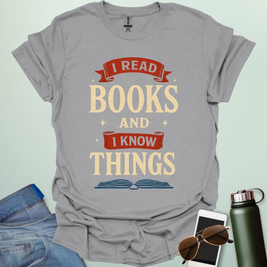A sport grey t-shirt with the text 'I READ BOOKS AND I KNOW THINGS' and a graphic of an open book below it.