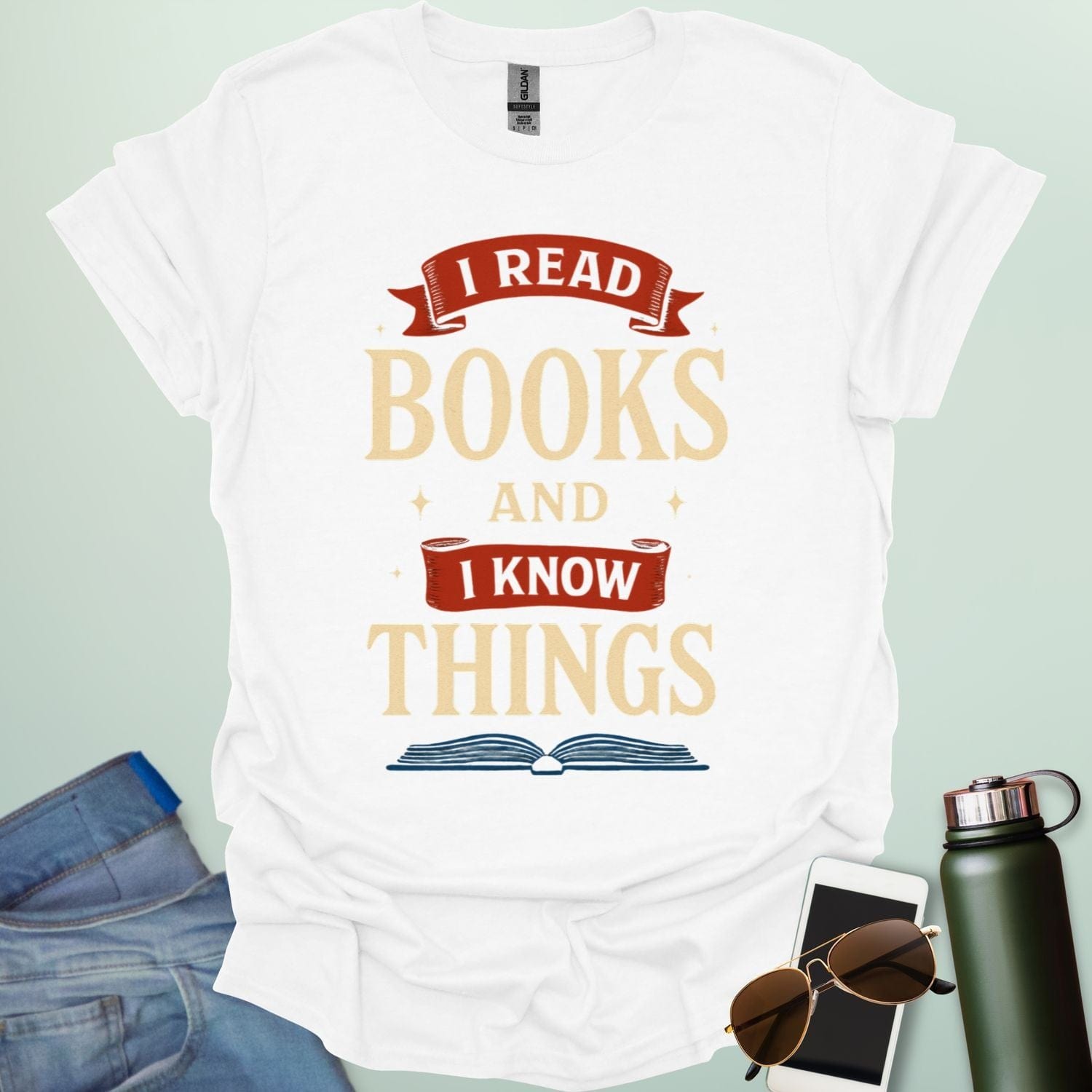 A white t-shirt with the text 'I READ BOOKS AND I KNOW THINGS' and a graphic of an open book below it.