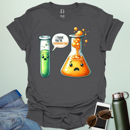 Charcoal gray t-shirt with a graphic of two test tubes and a beaker on a light gray background. The test tube says, "I THINK YOU'RE OVERREACTING"
