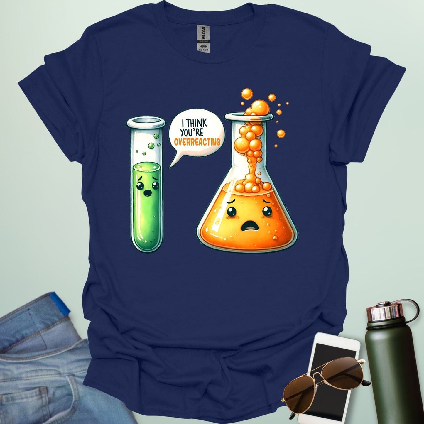 Navy blue t-shirt with a graphic of two test tubes and a beaker on a light gray background. The test tube says, "I THINK YOU'RE OVERREACTING"