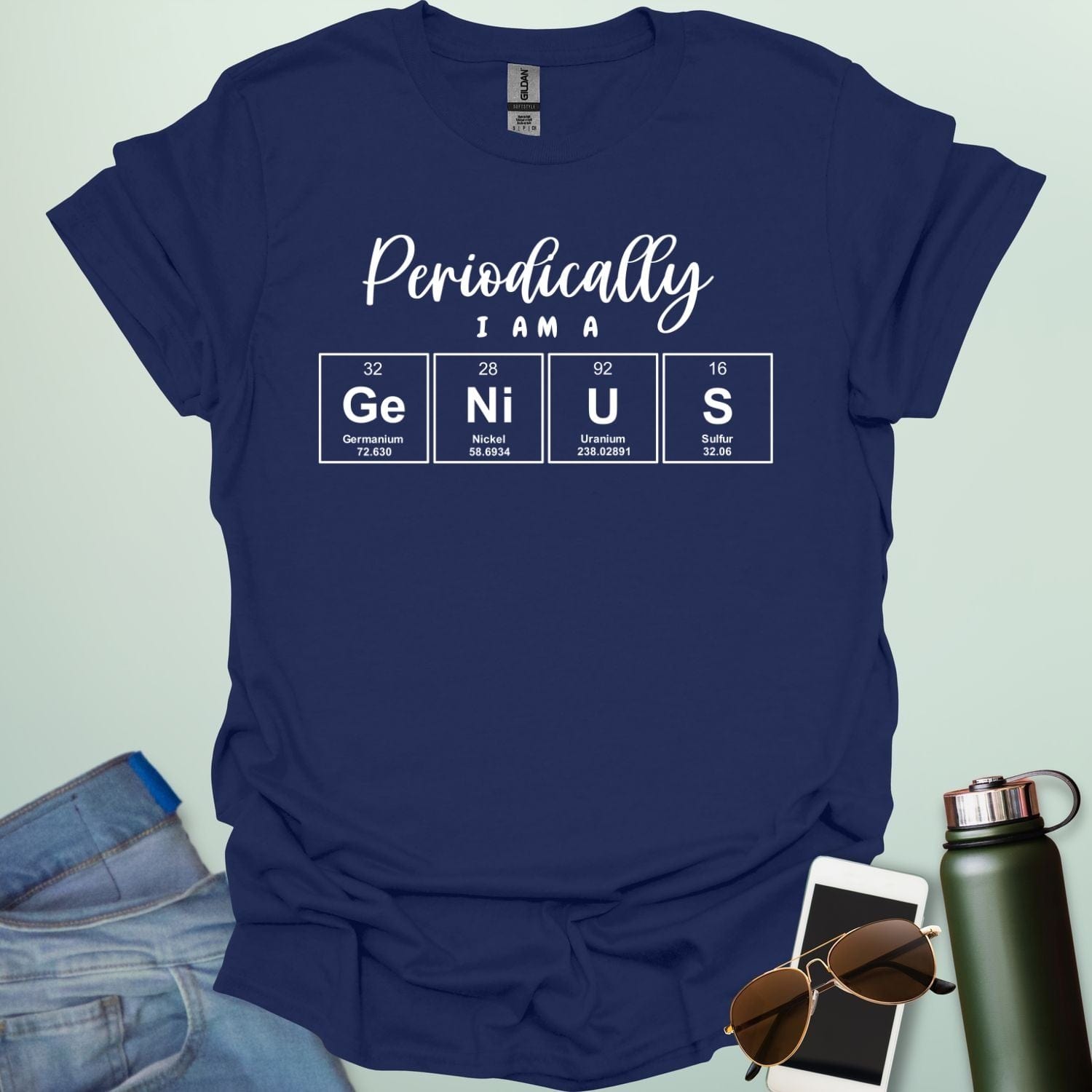 A navy blue t-shirt with the text 'Periodically I Am A Genius,' spelled out with the periodic table elements Ge, Ni, U, and S.
