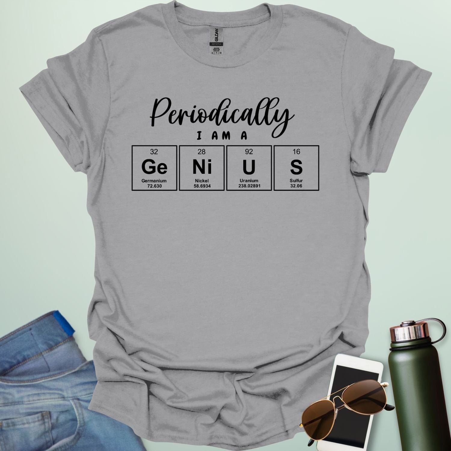 A sport grey t-shirt with the text 'Periodically I Am A Genius,' spelled out with the periodic table elements Ge, Ni, U, and S.