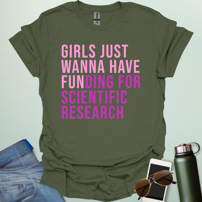 A military green t-shirt with the phrase 'Girls just wanna have funding for scientific research' in a bold, pink sans-serif font.