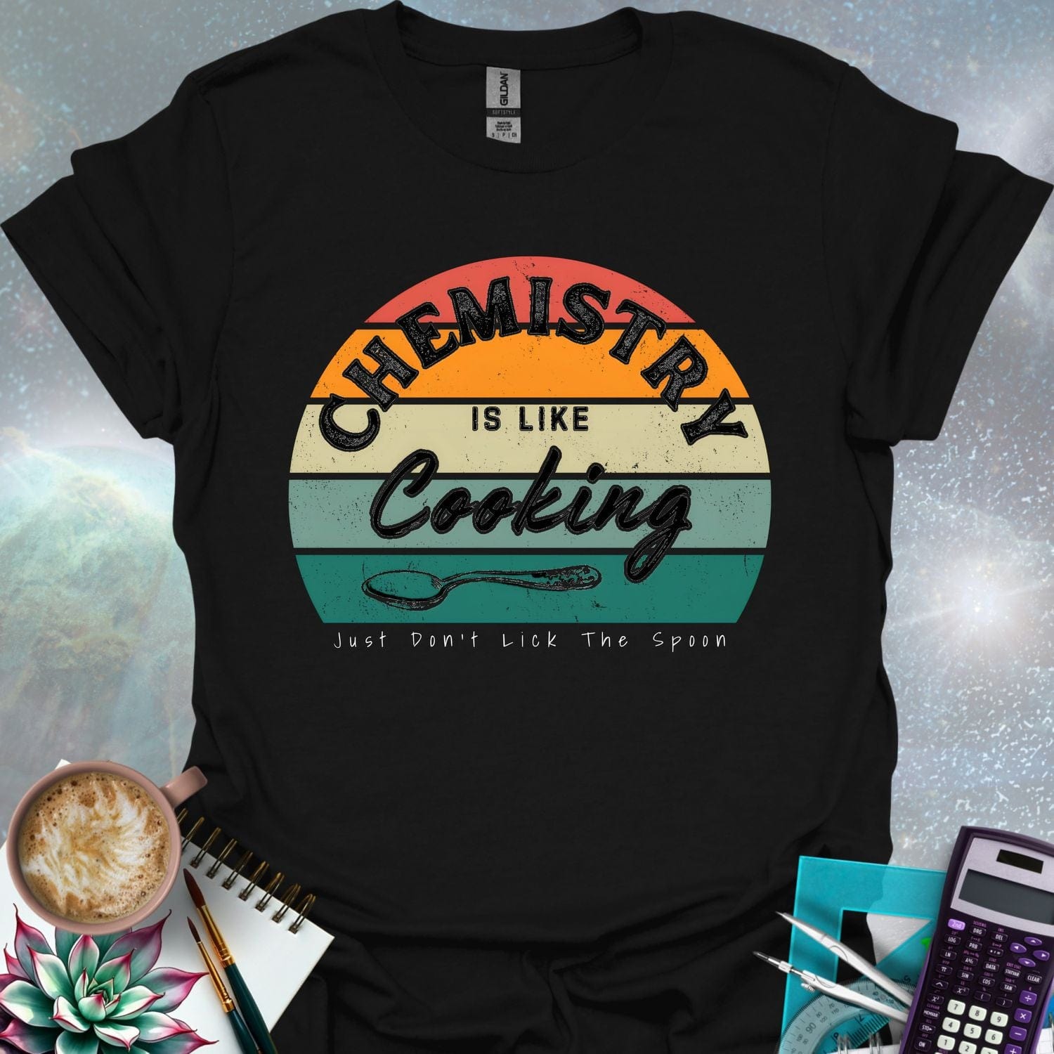 The text 'Chemistry is like Cooking - Just don't lick the spoon' in a distressed, grunge font, with a spoon graphic and a retro-style sunset background.