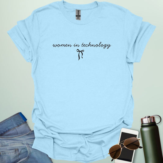 A light blue t-shirt with the phrase 'women in technology' in an elegant cursive font, with a small bow underneath.
