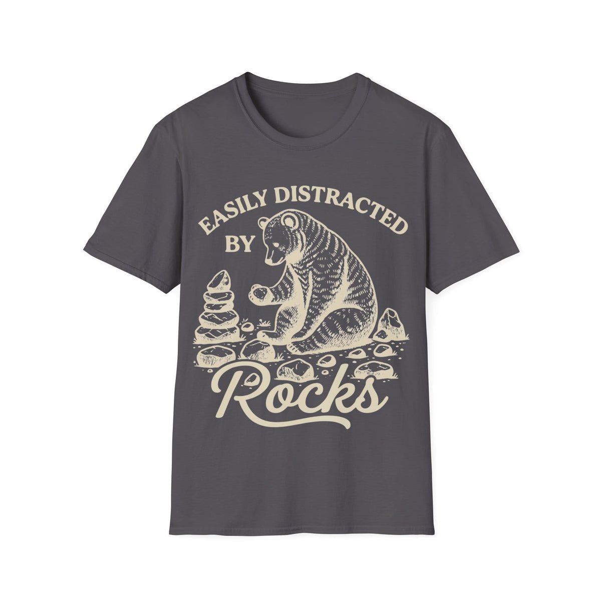 Linocut-style illustration of a bear sitting down examining a stone beside a cairn stack, framed by text reading 'EASILY DISTRACTED BY ROCKS'.