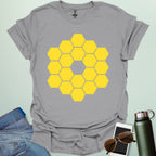A yellow icon representing the James Webb Space Telescope's hexagonal mirror array.