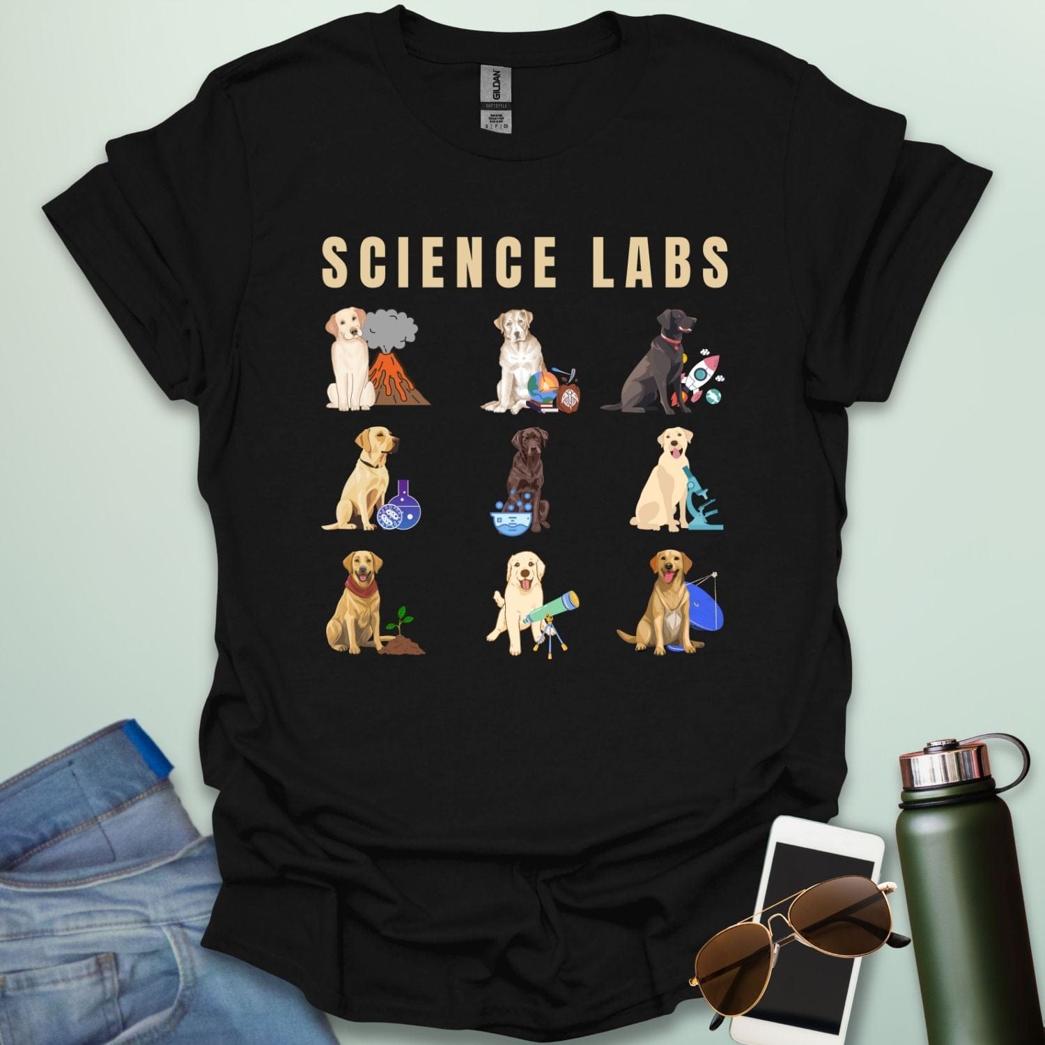 A black t-shirt with the text 'SCIENCE LABS' and a grid of nine illustrations of Labrador Retrievers in various science-themed scenarios.