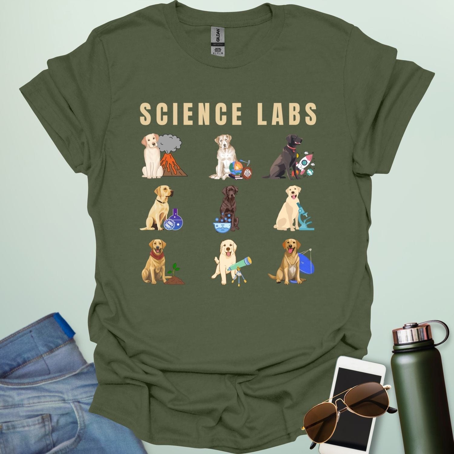 A military green t-shirt with the text 'SCIENCE LABS' and a grid of nine illustrations of Labrador Retrievers in various science-themed scenarios.