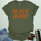 A military green t-shirt with the bold, distressed text 'THE LIFE OF AN ARTIST.'