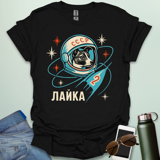 Laika First Dog in Space t-shirt with retro Soviet cosmonaut design featuring Laika in a helmet and rocket ship illustration.