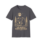 Vintage linocut-style illustration of a bear sitting beside a backpack, gazing up at a full moon over mountains and pine trees with text reading 'THE MOON IS WORTH THE WALK'.
