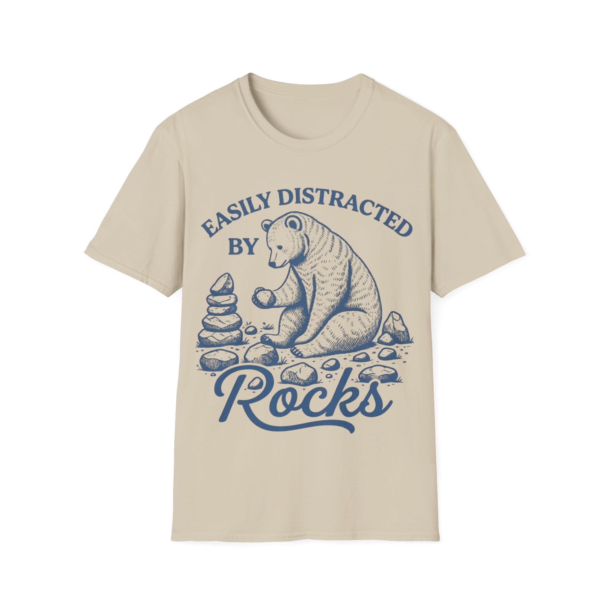 Linocut-style illustration of a bear sitting down examining a stone beside a cairn stack, framed by text reading 'EASILY DISTRACTED BY ROCKS'.