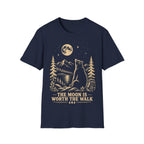 Vintage linocut-style illustration of a bear sitting beside a backpack, gazing up at a full moon over mountains and pine trees with text reading 'THE MOON IS WORTH THE WALK'.