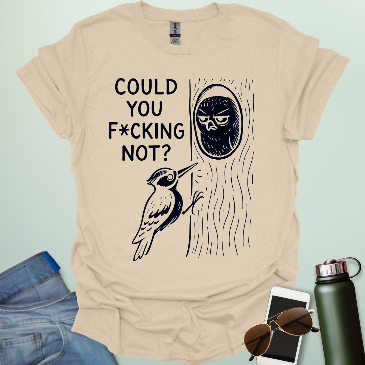 Minimal illustration of an irritated owl peeking from its tree burrow while a woodpecker pecks at the trunk, with bold text reading “COULD YOU F*CKING NOT?” on a dark background.