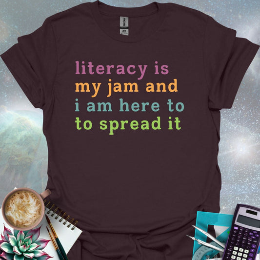 T-shirt with the text 'literacy is my jam and i'm here to spread it' in colorful, bold lettering.