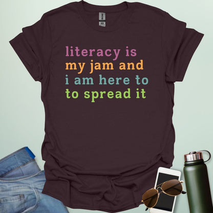 Dark chocolate T-shirt with the text 'literacy is my jam and i'm here to spread it' in colorful, bold lettering.