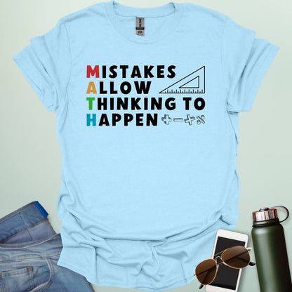A light blue t-shirt with the text 'MISTAKES ALLOW THINKING TO HAPPEN,' with the first letter of each word forming 'MATH' vertically, and a ruler and math symbols.