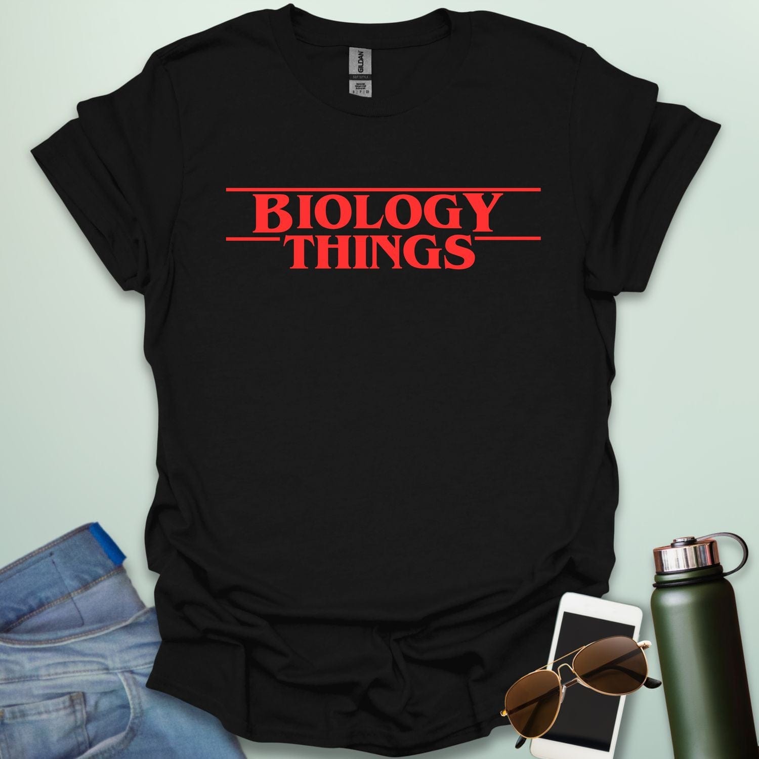 The words 'BIOLOGY' stacked above 'THINGS' in a red, stylized font with horizontal lines above and below, as a parody of the 'Stranger Things' logo.