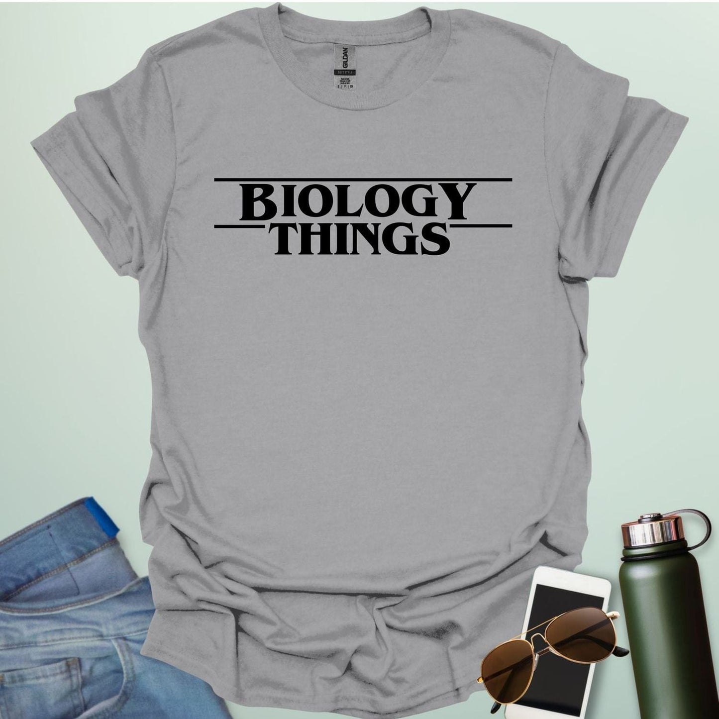 The words 'BIOLOGY' stacked above 'THINGS' in a red, stylized font with horizontal lines above and below, as a parody of the 'Stranger Things' logo.